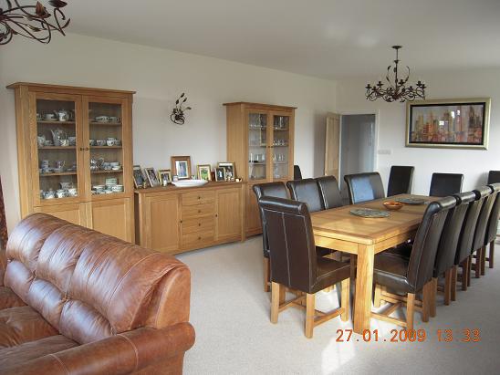A happy customers dining room with the 2.8 - 3.8m Tallinn table and brown Titan chairs and a pair of Georgia display units and Baltic Sideboard.